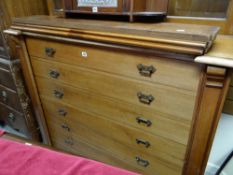 An early twentieth century mahogany library bookcase with a base of seven drawers