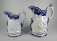 A GRADUATED PAIR OF YNYSMEUDWY JUGS (attributed to) with relief decoration to both sides of two boys
