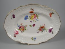 A NANTGARW PORCELAIN OVAL DISH moulded with sea-scrolls, flowers & wreaths, the interior painted