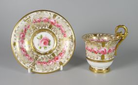 A NANTGARW PORCELAIN CUP & SAUCER, the footed cup with elevated gryphon ring-handle picked out in
