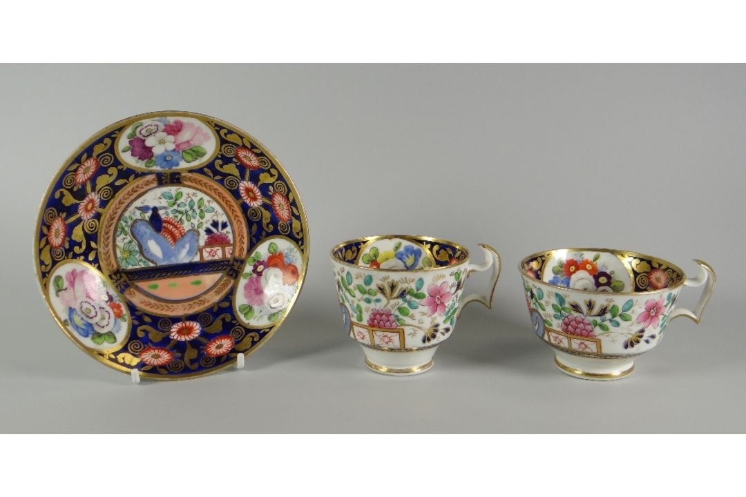 A SWANSEA 'JAPAN' TEA & COFFEE TRIO decorated in the Imari palette with reserves of garden flowers - Image 1 of 3