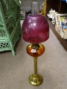 Reeded column brass oil lamp with amber glass reservoir and pink glass shade and chimney