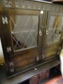 Carved front Priory style oak bookcase cabinet