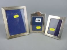 Two silver portrait frames and one other