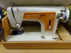 Cased Frister & Rossman portable sewing machine