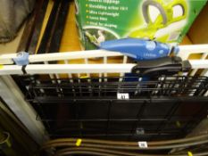 Black metal pet cage and two safety gates