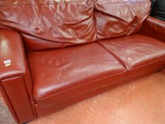 Stylish red leather effect three seater settee