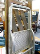 Wooden stepladder and a metal stepladder