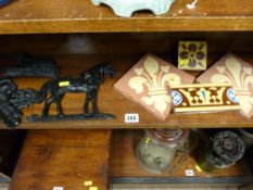 Four vintage floor tiles and three small cast iron doorstops