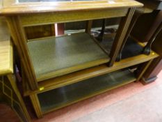 Two modern glass topped tables with raffia covered base shelves