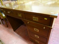 Reproduction mahogany campaign style desk with inset brass handles and corner mounts