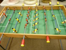 Tabletop football game on fold-out metal legs