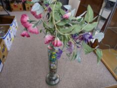 Glass vase of colourful stones in an artificial floral display