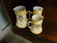 Graduated set of three Crown Devon blush decorated jugs