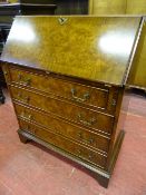 A REPRODUCTION WALNUT FALL FRONT BUREAU CHEST on corner bracket feet, 96 cms high, 80 cms wide, 43