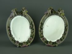 A PAIR OF GERMAN PLAUE PORCELAIN CHERUB & FLORAL ENCRUSTED MIRRORS, 27.5 x 21.5 cms