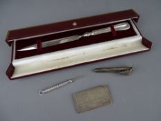 FOUR ITEMS OF HALLMARKED SILVER to include a cased letter opener, a posy holder, an open and retract