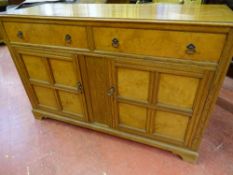 A VINTAGE OAK SIDEBOARD with burr walnut veneer drawer fronts and door panels on corner bracket