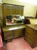 A REPRODUCTION OAK FOUR PIECE BEDROOM SUITE with Gothic carved detail, 180 cms high, 122 cms wide