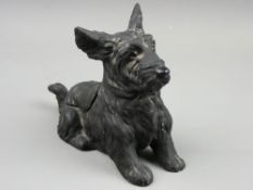 A CAST METAL SCOTTIE DOG STRIKER, 10.5 cms high, 13.5 cms long