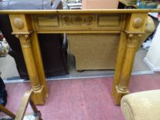 Pine fire surround with carved pillars and carved frieze