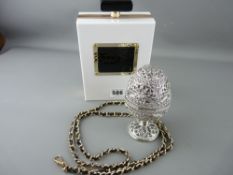 Stylish modern handbag in the form of a scent bottle and a filigree presentation egg with interior
