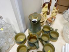 Fifteen piece Art pottery coffee set including coffeepot, pair of composition boy and girl figurines