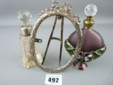 Butterfly decorated scent bottle and one other with a hallmarked silver portrait frame