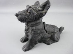 Cast metal striker in the form of a Scottie dog having hinged head and back