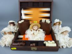 Five small bisque dolls in costume and a travelling backgammon game