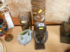 Three tribal type carved wooden figurines and a metal vase in the form of two peacocks