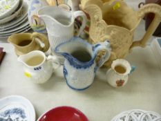 Group of five relief moulded jugs marked 'Wedgwood', 'Portmeirion' etc and a Carlton china crested
