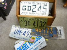 Pine magazine rack with quantity of USA vehicle registration plates