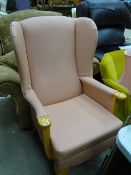 Light wood and pink upholstered wingback armchair