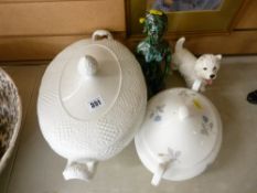 Two lidded vegetable tureens, mottled figure of a kneeling woman and a pottery Scottie dog