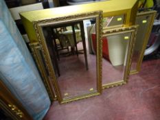 Four modern gilt framed wall mirrors