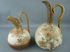 Two Doulton Burslem floral decorated stoneware ewers with gilt handles