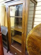 Glazed display unit of three shelves with lower drawer