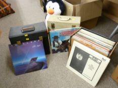 Three vinyl record holders with mixed contents