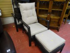 Two garden raffia chairs and small tables along with a parasol