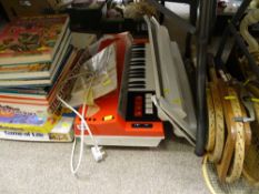 Parcel of games, annuals, old tennis racquets and Bontempi Hit child's piano on stand