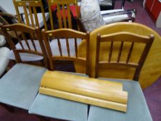 Circular extending dining table and five dining chairs