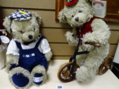 Two millennium collectable teddy bears, one on a bicycle