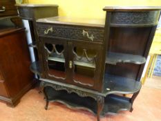 Polished wood display unit with central glazed doors and lower shelf