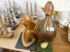 Large wooden model of a duck and egg and a wooden abstract seated figurine