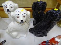 Pair of black and a pair of white Staffs dogs