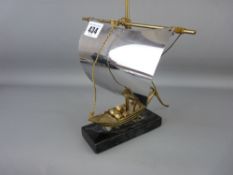 Yellow and white metal model of a sailing boat