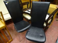 Two black high back upholstered dining chairs