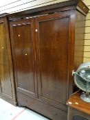 Edwardian mahogany wardrobe above a single drawer