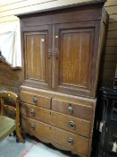 A nineteenth century oak press cupboard with a base of two long & two short drawers